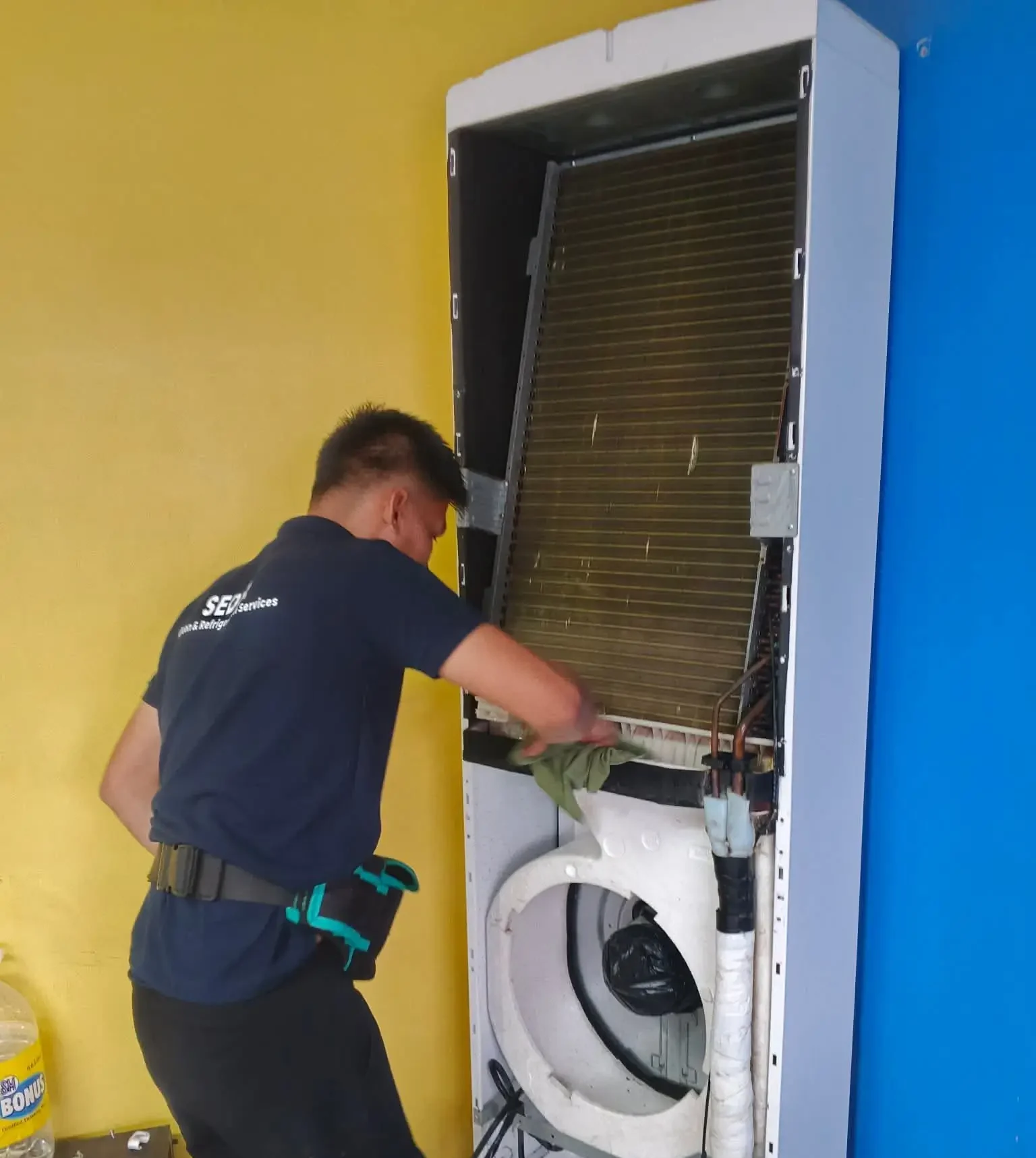Technician servicing wall AC unit